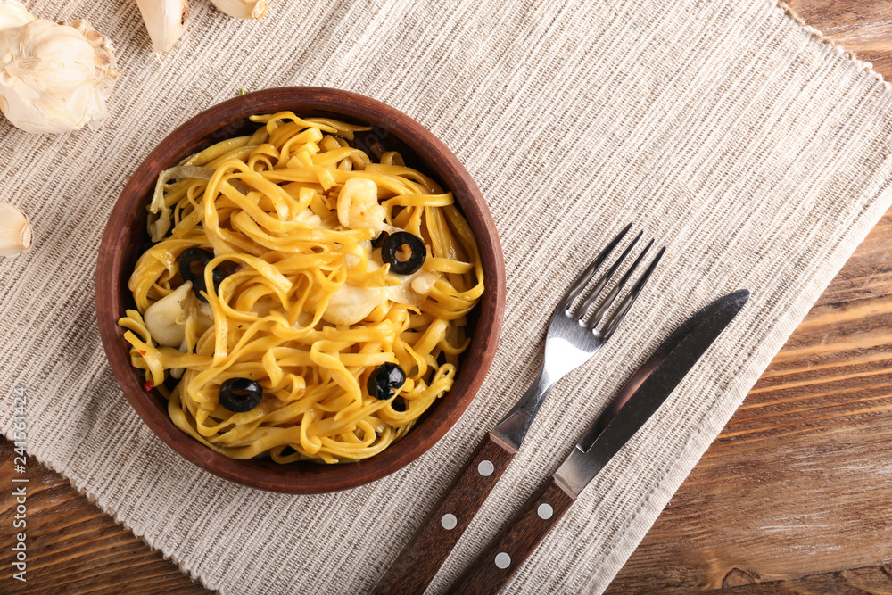 Plate with tasty pasta on table