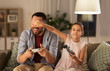 © Syda Productions - family, gaming and entertainment concept - happy father and little daughter with gamepads playing video game at home