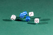 © Kruwt - Six white and blue dices falling on a green table