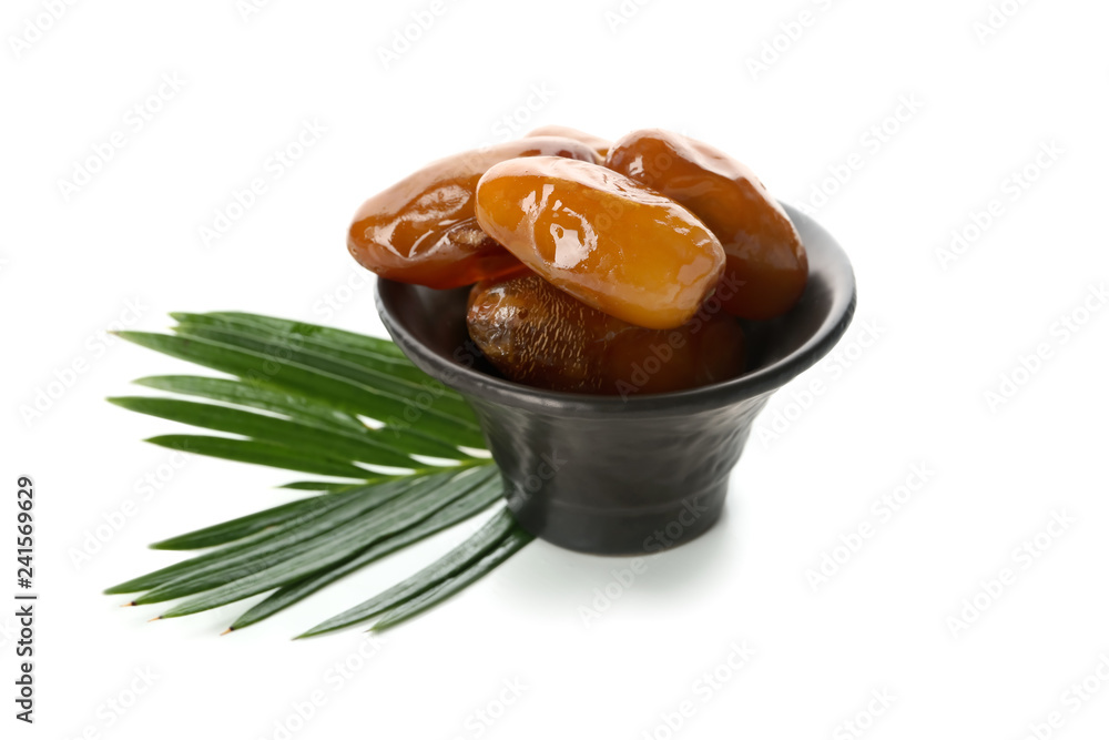 Bowl with sweet dried dates on white background