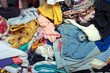 © varandah - Pile of messy clothes in closet. Untidy cluttered woman.