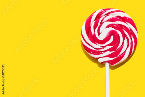 Red lollypop on yellow background Poster Mural XXL