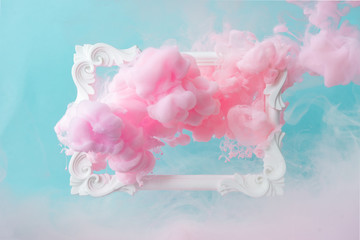 white vintage frame on pastel blue background with abstract pink cloud shapes. minimal border compos