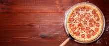 Classic Italian Pizza On A Wooden Tray, Served In A Small Authentic Italian Restaurant