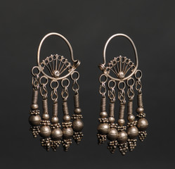 ancient antique earrings on black background. Middle-Asian vintage jewelry