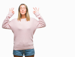 Poster - Young beautiful woman wearing winter sweater over isolated background relax and smiling with eyes closed doing meditation gesture with fingers. Yoga concept.