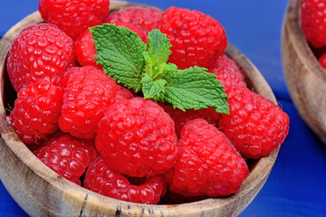 Sticker - Raspberries in a bowls on a wood table