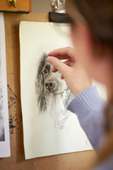 Wall Mural - Rear View Of Female Teenage Artist Sitting At Easel Drawing Picture Of Dog  In Charcoal