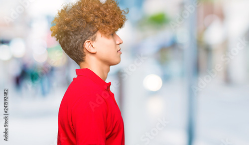 Young Handsome Man With Afro Hair Wearing Red T Shirt Looking To