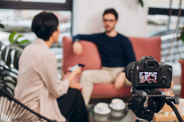 online show . life programme.camera recording the chat between a woman and a guy. transmitting programs to an audience