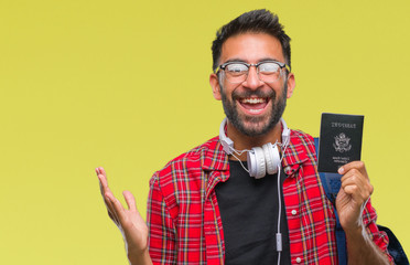 Poster - Adult hispanic student man holding passport of america over isolated background very happy and excited, winner expression celebrating victory screaming with big smile and raised hands