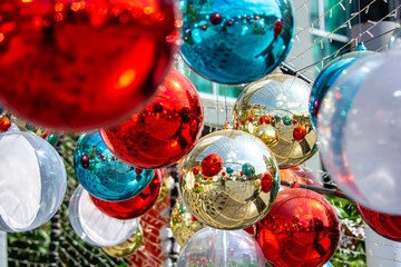 Wall Mural - Christmas balls decoration with twinkling light and ornament on fir over colorful bokeh with festive. Shiny xmas glass baubles ball background. Merry Christmas and Happy New Year.