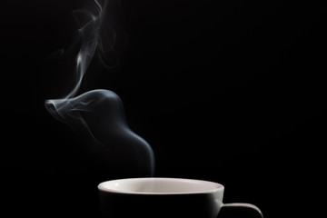 Fragrant coffee on a black background for your advertising. Smoke from hot coffee.