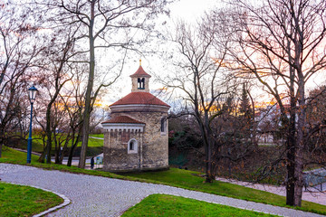 Wall Mural - Prague, Czech republic: Panorama of Vysehrad basilica during the sunset. Orange clouds above the ancient church in czech capital