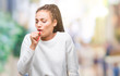 © Krakenimages.com - Young braided hair african american girl wearing winter sweater over isolated background feeling unwell and coughing as symptom for cold or bronchitis. Healthcare concept.