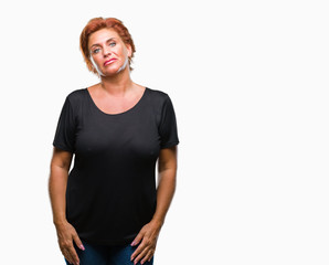 Canvas Print - Atrractive senior caucasian redhead woman over isolated background with serious expression on face. Simple and natural looking at the camera.