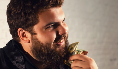 Young man in blue shirt making a thoughtful or sexy gesture touching his chin