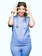 Poster - Young adult doctor woman wearing medical uniform Trying to open eyes with fingers, sleepy and tired for morning fatigue