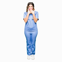 Sticker - Young adult doctor woman wearing medical uniform shocked covering mouth with hands for mistake. Secret concept.