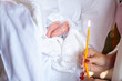 © Надія Коваль - A fragment of a photograph of a little girl preparing for a baptismal ceremony, her legs on a white dress, baptism