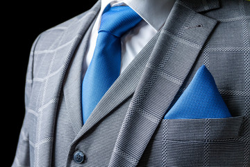 detail of a grey man suit with tie
