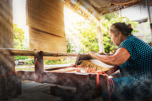 Asian Woman Weaving Typical Thai Straw Mat From Dry Papyrus