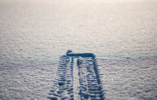 Tire tracks on winter road covered with snow