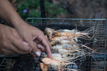 Grilled grilled on the grill with a hand holding the fork