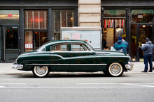 Side View Of A Classic Vintage Car In The Street In NYC