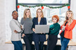 © alfa27 - diversity, race, height, success and people concept - international group of happy women standing with laptop portrait