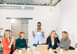 © alfa27 - Happy African business woman, group leader celebrating success with female members of her team, being overjoyed, clapping hands with the others at meeting.
