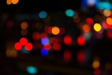 Abstract Red Bokeh Lights On Road Street In City Night Light Background, Decoration In Soft For Greeting Card Backdrop With Glitter Sparkle Blurred Circles
