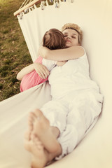 Sticker - mother and a little daughter relaxing in a hammock