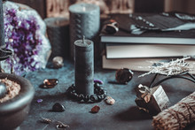 Black Candle On A Witch's Altar For A Magical Ceremony Among Crystals And Black Candles.