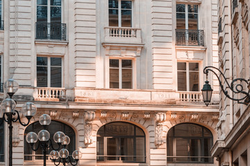 View from below on a facade European building in Paris, France. Neoclassicism  architecture style.