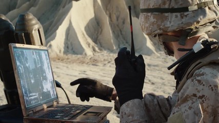 Poster - Military Operation in the Desert, Using Satellite or Drone Technology: Soldier with Laptop Monitors Movement of Armed Terrorist Vehicle, Uses Radio Communication to Call an Air Strike.