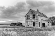 Old Farmhouse And Tractor In Black And White Photo