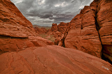 A Stormy Day Contrasts With The Colorful Sandstone At Red Rocks State Park NV.