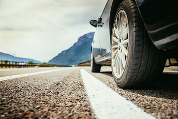 Tyre of a car on the emergency lane, breakdown on the highway. Copy space. 