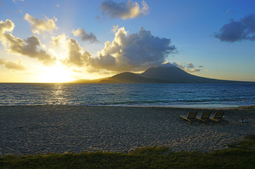 Wall Mural - Sunset view of the Nevis Peak volcano across the Caribbean Sea from St Kitts