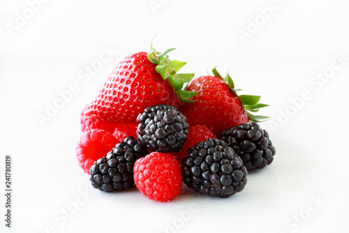 Fotografie, Obraz Pile of fresh berries on a white background including strawberries, blackberries