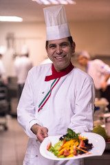 Chef showing a plate of tasty meal