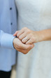 © Jammer Gene - Newlyweds holding hands with ring visible