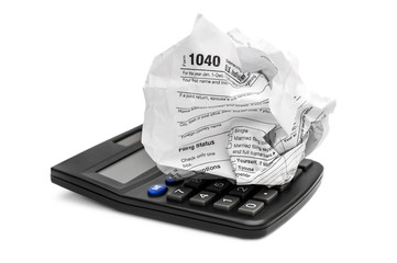 Wall Mural - Crumpled tax form with calculator on white.