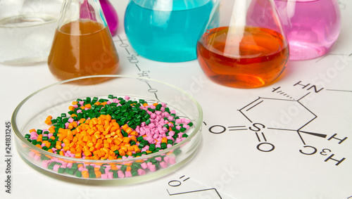 Cuadros en Lienzo Plastic raw material in granules against the background of Chemical Laboratory and reagents