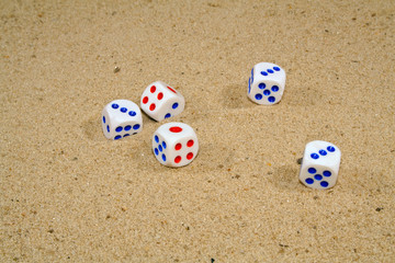 playing dice on yellow sand