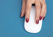 © schankz - White mouse in the hand of the girl on a blue background
