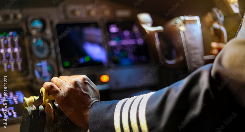 Cropped Hands of African Pilot flying a commercial airplane - obrazy, fototapety, plakaty 