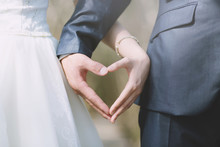Close Up Groom Hand And Bride. Young Male And Female Couple Marry Show Holding Hands Make Heart Shape Over. Newly Wed Couple Hands. Concept Lover Wedding Ceremony. 