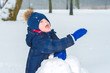 © Olek - little boy waving his hand in the snow. the child is playing